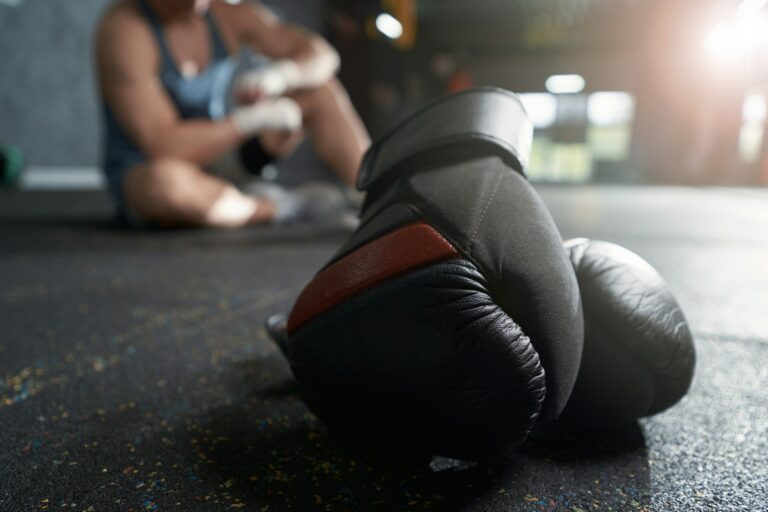 Protective boxing gear and athlete resting after workout