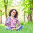 Indian girl with notebook in the park.